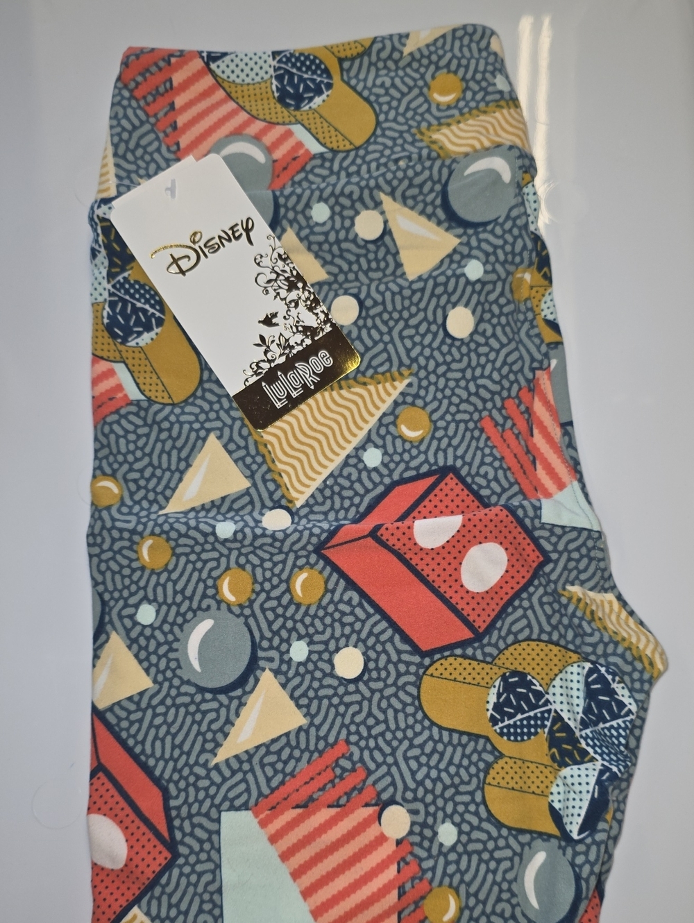 LuLaRoe Leggings with Blue, Coral, Yellow, Cream Geometric Mickey Pattern